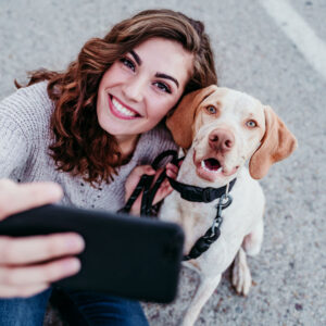 lady taking selfie with dog as he is on a walk