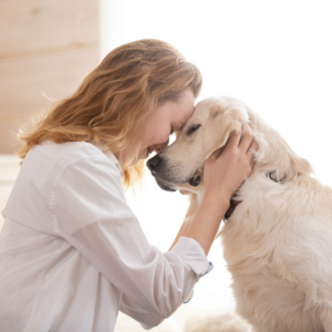 woman lovingly embracing her rescue dog at home